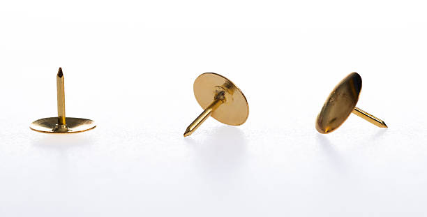 Group of thumbtacks in low light