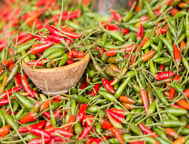 istock Colorful chili peppers in rustic bowl 2227707042