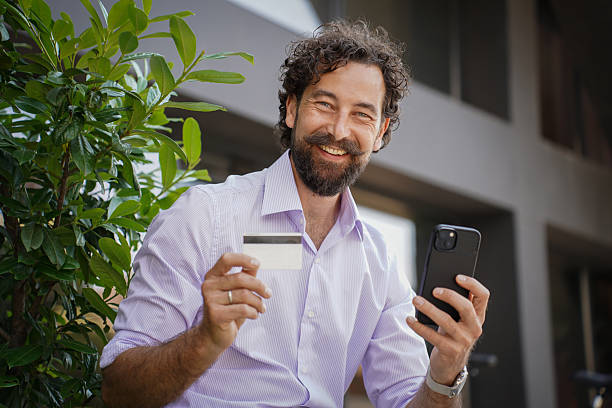 istock Middle-aged man making online payment with smartphone and credit card 2227707076