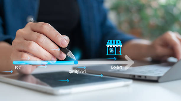 istock Hand using a stylus to adjust quality level on tablet with franchise store icon. Concept of performance review, business quality assessment, and rating improvement. 2227709547
