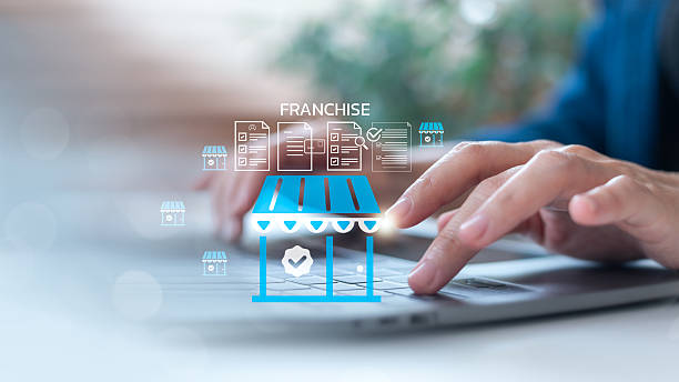 istock Hands typing on a laptop with franchise store icons and a document checklist interface. Concept of business registration, license approval, and franchise system. 2227710224
