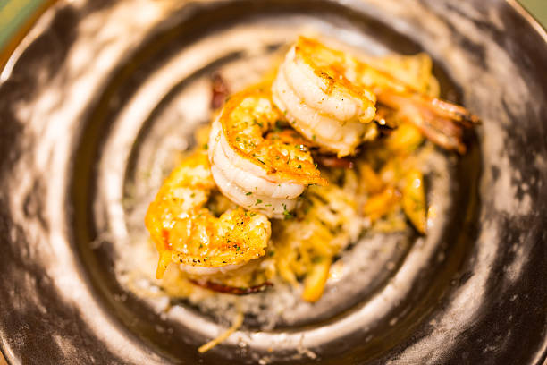 Delicious grilled shrimp spaghetti dish on plate enticing presentation. Top view