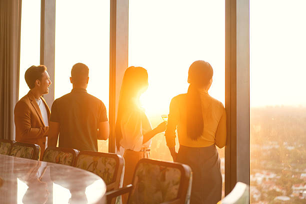 istock Coworkers winding down after work hours at a rooftop restaurant 2227710254