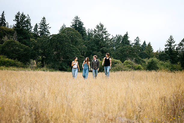istock Friends Walking In Rural Grass Field 2227711188