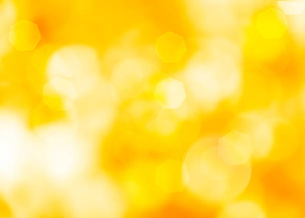 istock Abstract magic bokeh lights. defocused lights on a yellow orange background blur 2227713272