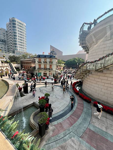 Hong Kong, China - December 29, 2024: 1881 Heritage plaza, located in the Tsim Sha Tsui district of Kowloon, Hong Kong. This luxury shopping and lifestyle destination is housed in the former Marine Police Headquarters compound. The scene features Victorian-style architecture, festive decorations, and a crowd of people exploring the open-air square