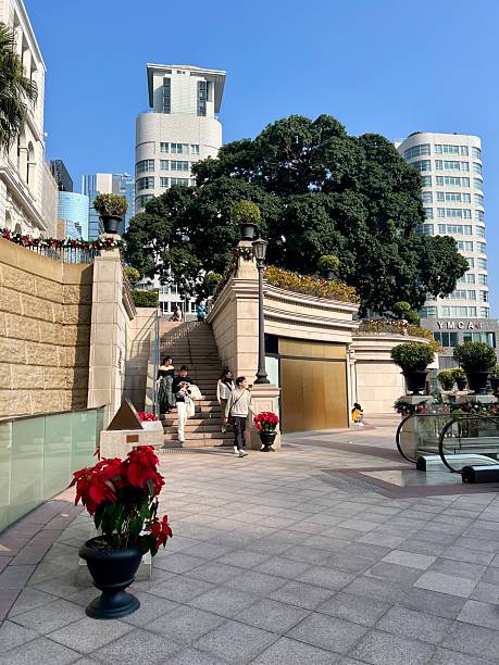Hong Kong, China - December 29, 2024: 1881 Heritage plaza, located in the Tsim Sha Tsui district of Kowloon, Hong Kong. This luxury shopping and lifestyle destination is housed in the former Marine Police Headquarters compound. The scene features Victorian-style architecture, festive decorations, and a crowd of people exploring the open-air square