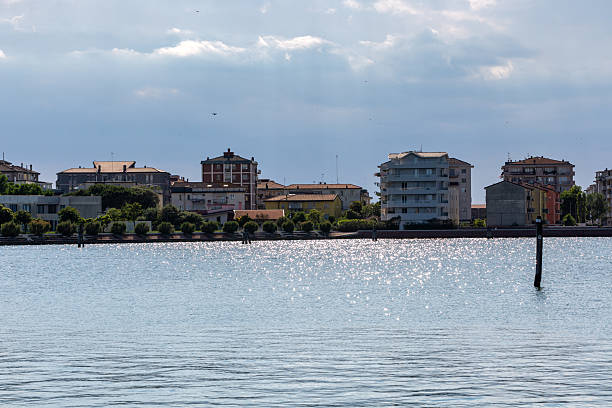Grado, Italy - March 28, 2017: The old harbor of Grado and surrounding buildings in sunset light.  Northeast Italy, Europe.