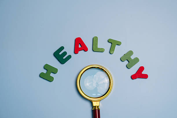 istock Magnifying Glass Over Colorful Letters Spelling Healthy 2227716216