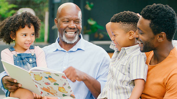 istock Smiling Multi-Generation Family Reading Book In Garden Together 2227717708