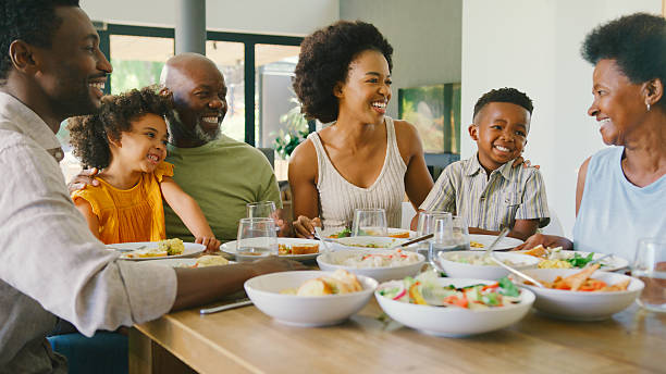 istock Multi-Generation Family Sitting Around Table Eating Meal At Home Together 2227717769
