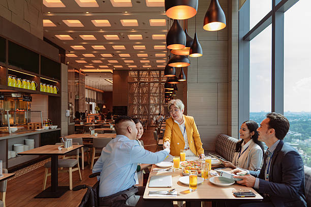 istock Diverse Asian business team lunch and network session hosted by a senior female executive 2227719932