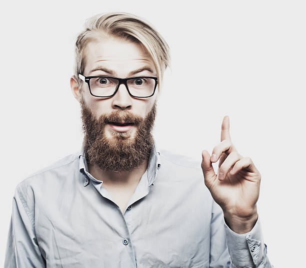 istock young bearded man with good idea sign. 2227720329