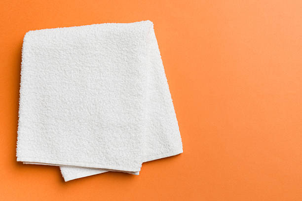 istock Top view of white towels with copy space on colored background 2227720751