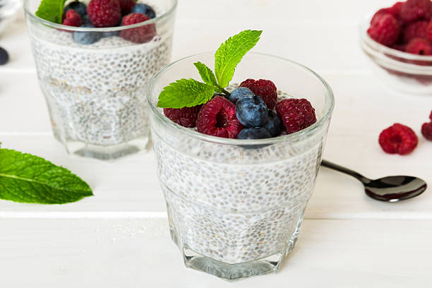 istock Healthy breakfast or morning with chia seeds vanilla pudding raspberry and blueberry berries on table background, vegetarian food, diet and health concept. Chia pudding with raspberry and blueberry 2227720877