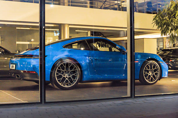 Almaty, Kazakhstan - July 11, 2025: New Porsche 911 inside the showroom. German luxury carmaker