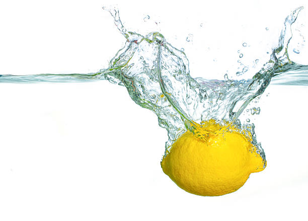 Fresh Lemon Splashing Into Clear Water Creating Vibrant Bubbles