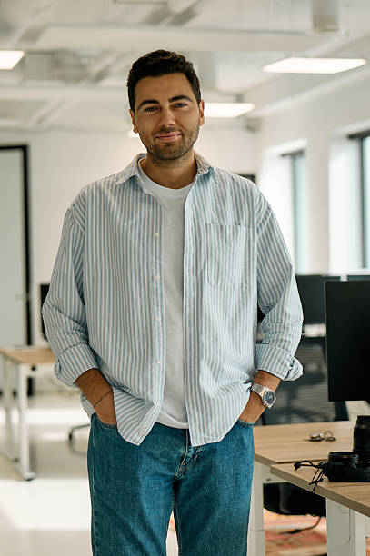 istock Confident young businessman smiling in modern office 2227728644