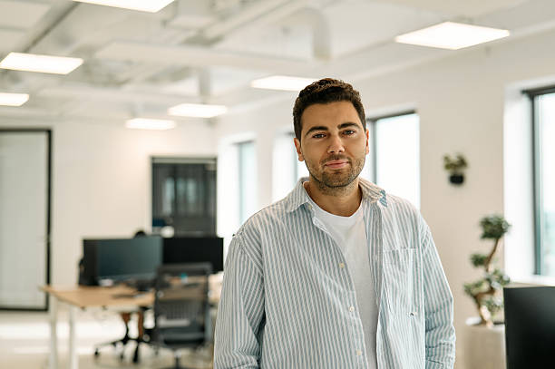 istock Confident businessman smiling in modern office setting 2227728706
