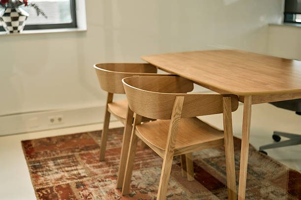 istock Modern wooden table and chairs illuminating a contemporary office space 2227728769