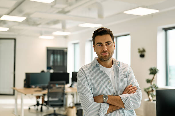 istock Confident businessman crossing arms in modern office 2227728770