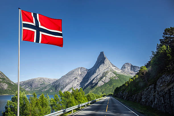 Sjoa, Norway-July 30, 2017 Wooden sculptures with Norwegian flags in the entrance of Sjoa village. Oppland, Norway