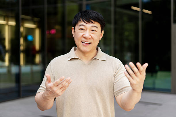istock Asian businessman gesturing in front of office building 2227734680