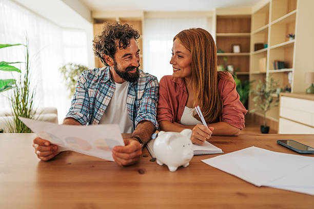 istock Couple analyzing charts and planning home budget together 2227736148