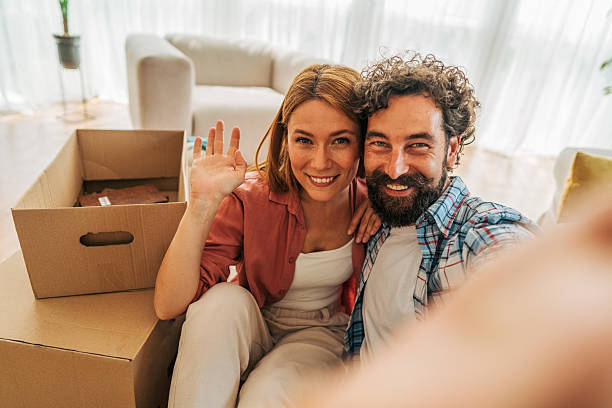 istock Happy couple taking selfie while moving into new home 2227737142
