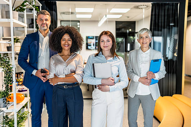 istock Smiling businesspeople posing together in modern office 2227738198