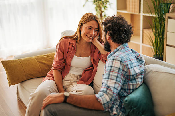 istock Young couple relaxing on sofa, sharing intimate moments at home 2227739874