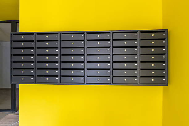 istock Modern black mailboxes with numbers and locks on a wall. Interior of an apartment building lobby, concept of mail, communication, and delivery service. 2227742940