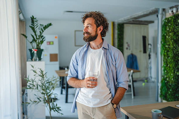 istock Creative entrepreneur relaxing and drinking water in modern office 2227744322