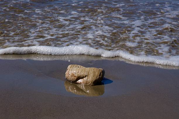 Large sedimentary rock along the shoreline
