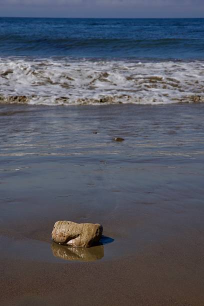 istock Large sedimentary rock along the shoreline 2227744844