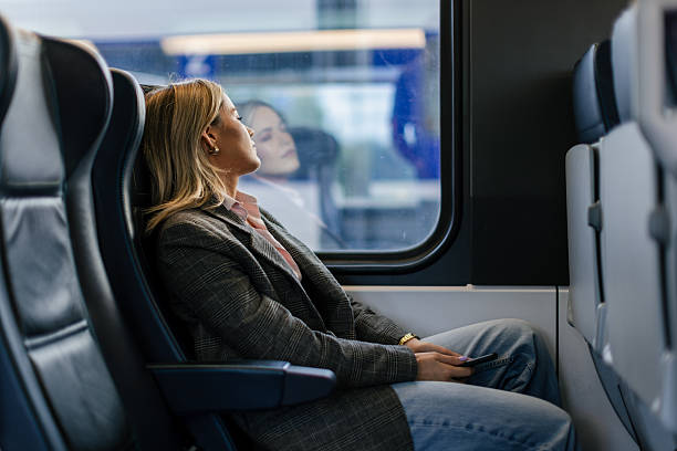 istock Business woman commuting to work on train 2227747042