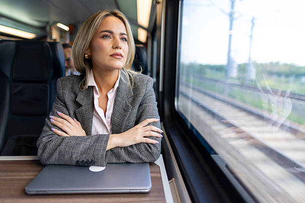 istock Business woman commuting to work on train 2227747337
