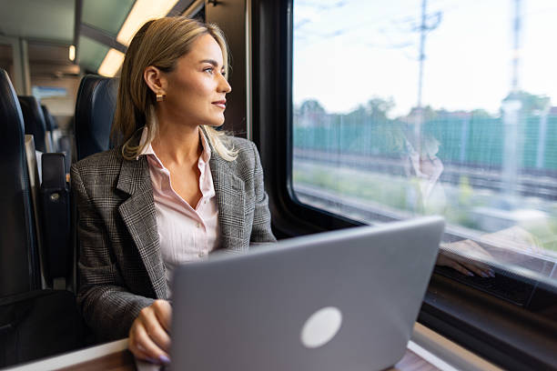 istock Business woman commuting to work on train 2227747338