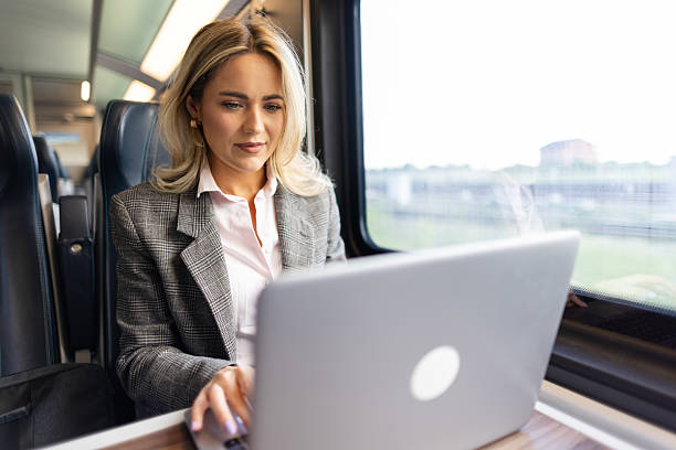 istock Business woman commuting to work on train 2227747344
