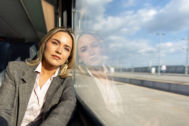 istock Business woman commuting to work on train 2227747386