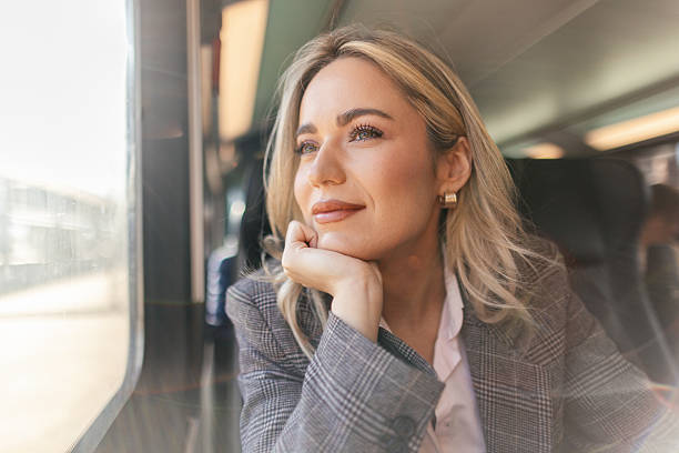 istock Business woman commuting to work on train 2227747390