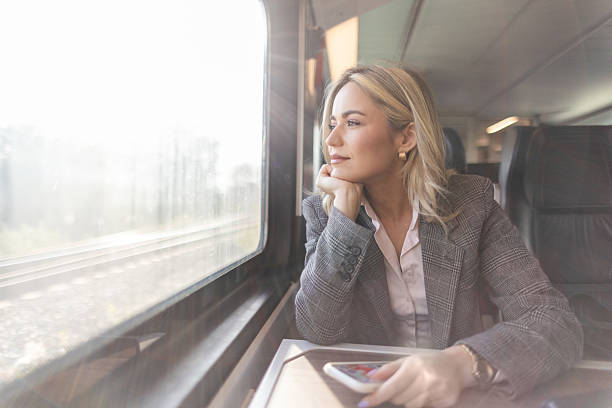 istock Business woman commuting to work on train 2227747396