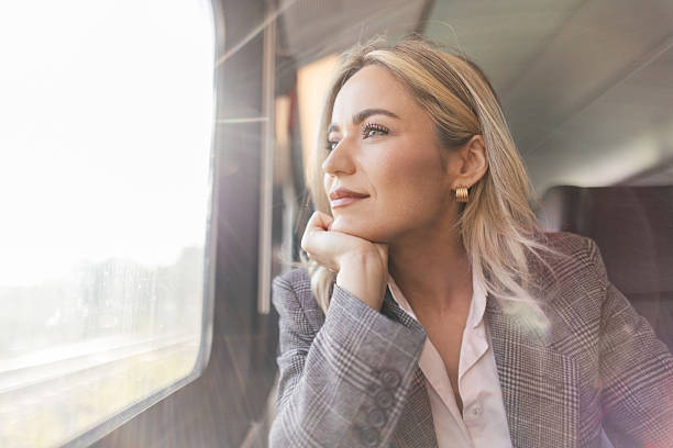 istock Business woman commuting to work on train 2227747402