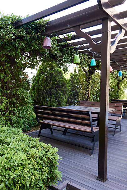 istock Wooden Bench And Table In Garden 2227747991