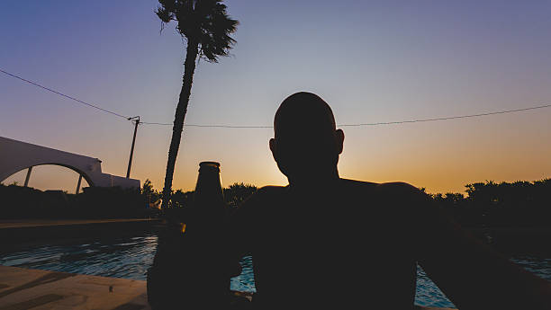 mature adult man relaxes and has fun in the pool