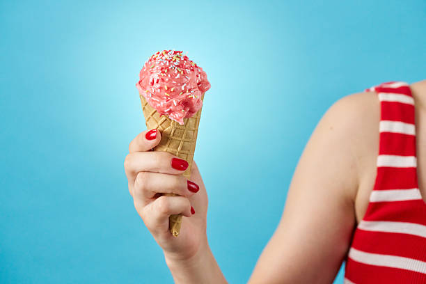 Dondurma Ice cream in child's hand on background of palm trees on a sunny summer day. Turkish mastic fruits ice-cream.