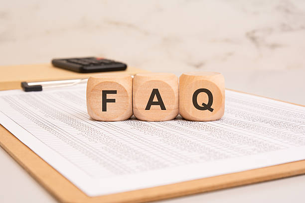 istock Wooden blocks with FAQ on a financial document. Frequently Asked Questions concept. 2227757859
