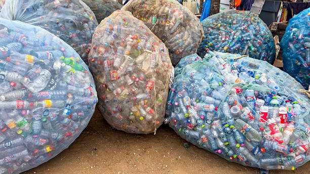 istock Plastic bottles in large mesh bags, ready for recycling. Waste management and environmental pollution, global crisis and the need for sustainability. 2227761647