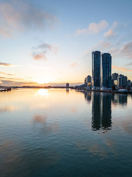istock Sunrise Over Cityscape with Skyscrapers Reflecting on Calm Waterfront 2227761903