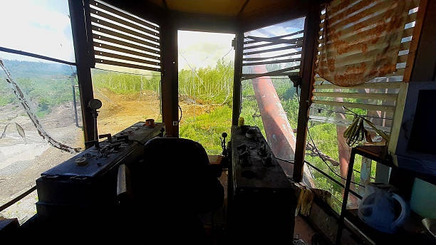 istock Control room overlooking a forested area with machinery and natural light during daytime 2227762451